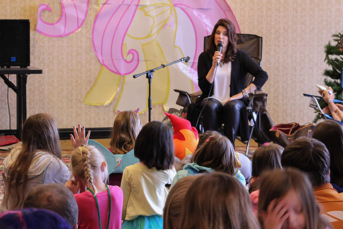 A group of familes gathering around a narrator.