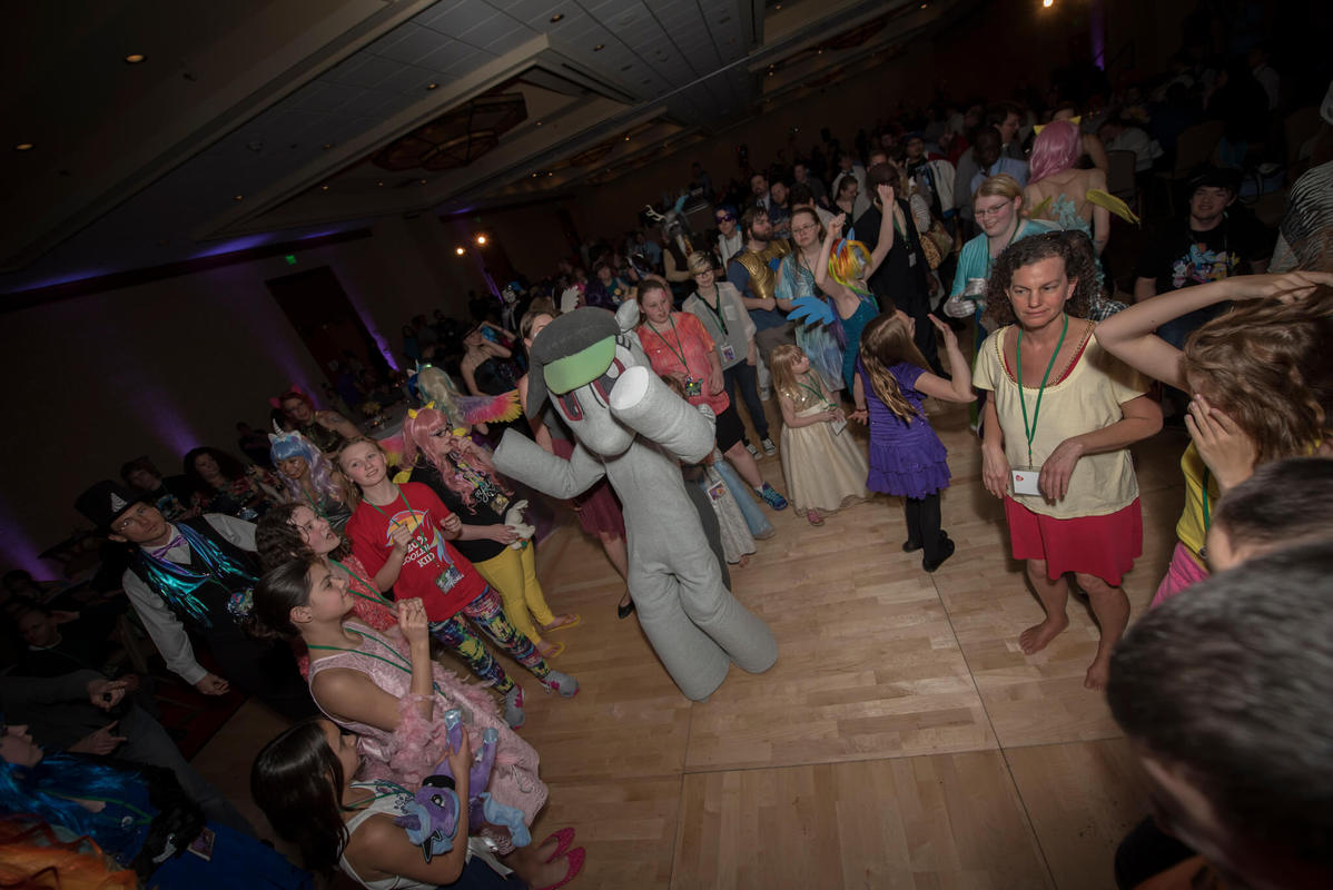 A group of children dancing in a ballroom.